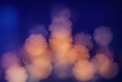 The primary subject of the image is a cloud formation in the sky. The setting is a dark blue sky, and the visual style appears to be a photo. The cloud formation is large and dominates the scene, creating a dramatic and moody atmosphere.