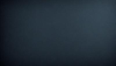 The primary subject of the image is a dark blue background. The setting is a black background, which creates a dramatic and moody atmosphere. The visual style is a simple, monochromatic design. The colors and mood are predominantly dark and mysterious.