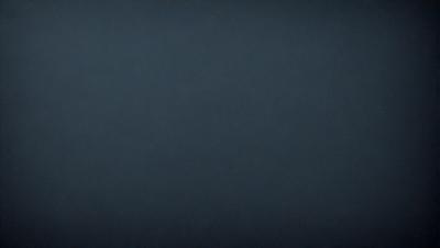 The primary subject of the image is a dark blue sky. The setting is a vast, open space with no visible landmarks or objects. The visual style is a simple, monochromatic image with no additional elements or textures. The colors and mood of the image are predominantly dark and moody, creating a sense of depth and vastness.