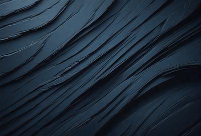 The primary subject of the image is a blue, textured surface that appears to be a wall or a piece of art. The setting is a dark room, and the visual style is a close-up of the blue surface. The colors and mood of the image are predominantly dark and moody, with the blue surface being the main focus.