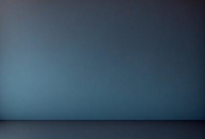 The primary subject of the image is a blue wall. The setting is a dark room, and the visual style appears to be a photo. The dominant colors are blue and black, creating a calm and serene atmosphere.