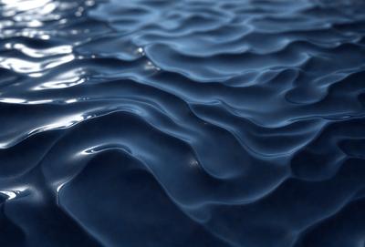 The primary subject of the image is a blue ocean with ripples and waves. The setting is the ocean, and the visual style is a photo. The dominant colors are blue and white, creating a calm and serene atmosphere.