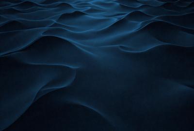 The primary subject of the image is a blue ocean with ripples and waves. The setting is the ocean, and the visual style is a photo. The dominant colors are blue and white, creating a calm and serene atmosphere.
