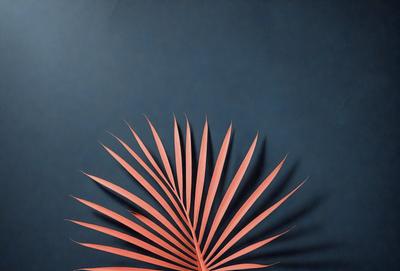 The primary subject of the image is a large, colorful, and intricately designed palm tree. The tree is prominently displayed against a blue wall, which serves as the setting or background. The visual style of the image is a combination of photo and digital art, creating a unique and eye-catching representation of the palm tree. The dominant colors in the image are pink and orange, giving the scene a vibrant and lively atmosphere.