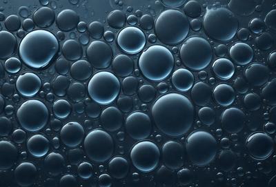The primary subject of the image is a close-up of a blue, bubbly surface, which appears to be a water-like substance. The setting is a dark background, which contrasts with the blue bubbles. The visual style is a close-up, which emphasizes the details of the bubbles. The colors and mood of the image are predominantly blue, creating a calm and serene atmosphere.