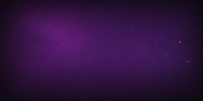 The image is a purple sky with a few stars visible. The sky appears to be a deep purple, creating a striking contrast with the stars. The stars are scattered throughout the sky, with some appearing closer to the viewer and others further away. The overall atmosphere of the image is serene and peaceful, with the purple sky and the stars creating a sense of calmness.