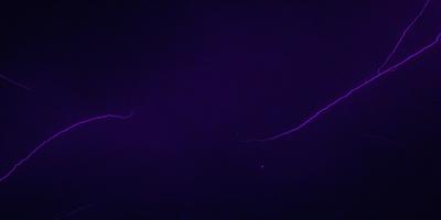 The image features a purple background with a bright yellow streak or lightning bolt. The purple hue creates a contrasting and visually striking scene. The yellow streak adds a dynamic element to the image, drawing attention to its presence. The overall atmosphere of the image is a mix of vibrant colors and a sense of motion, as the yellow streak seems to be moving or streaking across the purple background.