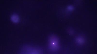 The image is a purple and blue night sky with a few stars visible. The primary subject is the night sky, which is the setting and background of the image. The visual style is a photo, and the colors and mood are predominantly purple and blue, creating a serene and peaceful atmosphere.