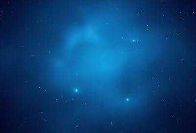 The primary subject of the image is a blue sky filled with stars. The setting is a night sky, and the visual style is a photo. The colors and mood of the image are predominantly blue, with a sense of tranquility and wonder.