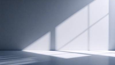The primary subject of the image is a window with a white frame. The setting is a white wall, and the visual style is a photo. The colors and mood of the image are predominantly white, creating a clean and minimalist atmosphere.
