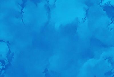 The primary subject of the image is a blue sky filled with clouds. The setting is a clear blue sky with no visible land or objects. The visual style is a natural, outdoor scene. The colors and mood are predominantly blue, creating a calm and serene atmosphere.