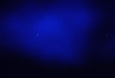 The primary subject of the image is a blue sky with a few stars visible. The setting is a dark blue background, which contrasts with the bright stars. The visual style is a photo, capturing the night sky with the stars and the dark blue background. The colors and mood of the image are predominantly dark and serene, with the blue sky and stars creating a peaceful atmosphere.