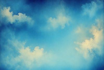 The primary subject of the image is a cloudy blue sky. The setting is a vast expanse of the sky, with no visible land or other objects. The visual style is a natural, outdoor scene, with no indication of digital art or illustration. The colors and mood of the image are predominantly blue and serene, creating a peaceful and tranquil atmosphere.