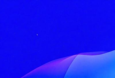 The primary subject of the image is a moon, which is visible in the sky. The setting is a blue sky, and the visual style appears to be a digital art or illustration. The dominant colors in the image are blue and white, creating a calm and serene atmosphere.