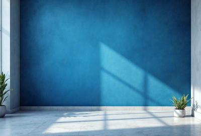 The primary subject of the image is a chair, which is placed in front of a blue wall. The chair is positioned in the foreground, and the blue wall serves as the background. The visual style of the image is a photo, capturing the chair and the blue wall in a realistic manner. The colors and mood of the image are predominantly blue, creating a calm and serene atmosphere.