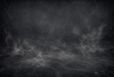 The primary subject of the image is a black background with a white, cloudy sky. The setting is a dark, foggy environment, creating a moody atmosphere. The visual style is a combination of a photo and digital art, as the image appears to be a blend of the two. The colors are predominantly black and white, with the white clouds adding a touch of contrast.