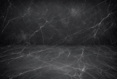 The primary subject of the image is a black and white photo of a marble countertop. The setting is a black background, which contrasts with the marble countertop. The visual style is a close-up of the marble countertop, showcasing its texture and pattern. The colors and mood of the image are predominantly black and white, giving it a classic and elegant appearance.