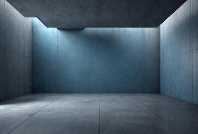 The primary subject of the image is a large, empty room with a blue wall. The setting is a concrete room, and the visual style is a black and white photo. The dominant colors are blue and gray, creating a calm and minimalistic atmosphere.
