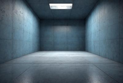 The primary subject of the image is a large, empty room with a blue cement floor. The setting is a concrete room with a blue cement wall, and the visual style is a photo. The room appears to be a large, open space with a blue color scheme, giving it a calm and serene atmosphere.