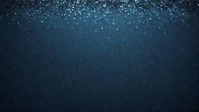 The primary subject of the image is a blue ocean with a few white specks, creating a visually appealing scene. The setting is the ocean, and the visual style is a photo. The dominant colors are blue and white, creating a serene and calming atmosphere.