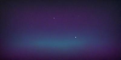 The primary subject of the image is the night sky, which is filled with stars. The setting is a dark, purple-colored background, creating a dramatic and serene atmosphere. The visual style is a photo, capturing the beauty of the night sky and the stars. The colors and mood of the image are predominantly purple, with the stars adding a touch of brightness and contrast.