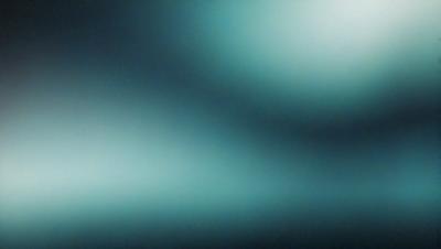 The primary subject of the image is a blue background with a greenish tint. The setting appears to be a dark room, and the visual style is a close-up of the background. The colors and mood of the image are predominantly dark and moody, with the blue and greenish tones creating a sense of depth and mystery.