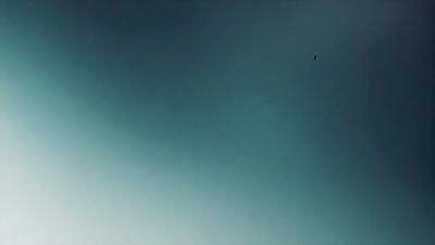 The primary subject of the image is a blue sky with a few clouds. The setting is a vast, open space with no visible landmarks or objects. The visual style is a natural, outdoor scene. The colors and mood are serene and peaceful, with the blue sky and clouds creating a calm atmosphere.