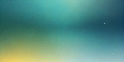 The primary subject of the image is a large, open sky with a few clouds. The setting is a vast, empty space with no visible landmarks or objects. The visual style is a natural, outdoor scene with a focus on the sky and clouds. The colors and mood of the image are predominantly blue and calm, creating a serene and peaceful atmosphere.