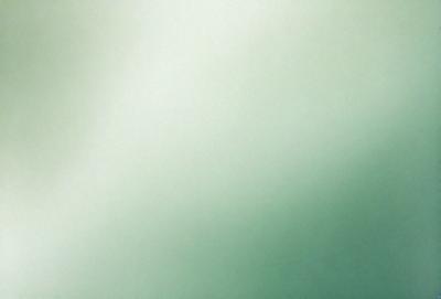 The primary subject of the image is a white wall with a green background. The visual style appears to be a photo, and the colors and mood are predominantly green, creating a calm and serene atmosphere.