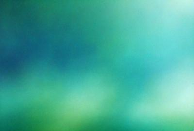 The primary subject of the image is a green, cloudy sky. The setting is a bright, sunny day with a clear blue sky. The visual style is a photo, capturing the natural beauty of the sky. The colors and mood are lively and vibrant, with the green hues of the sky creating a sense of freshness and tranquility.