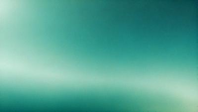 The primary subject of the image is a large, bright green background. The setting is a dark, empty space, with no visible objects or people. The visual style is a close-up of the green background, which creates a sense of depth and contrast. The colors and mood of the image are predominantly green, with a slightly darker tone, giving it a calm and serene atmosphere.