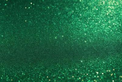 The primary subject of the image is a close-up of a green background with a pattern of glittering, shiny, and sparkling green and gold colors. The setting appears to be a dark room, and the visual style is a combination of a photo and digital art. The colors and mood of the image are vibrant, lively, and visually appealing.