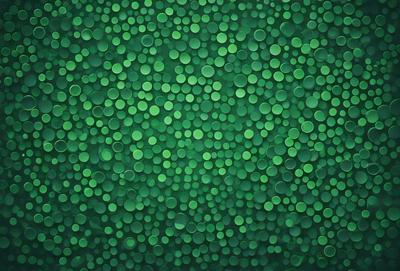 The primary subject of the image is a green background with a pattern of green circles. The setting is a wall or a surface, and the visual style appears to be a pattern or texture. The dominant colors are green, and the overall atmosphere is lively and vibrant.