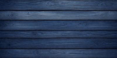 The primary subject of the image is a wooden wall with a blue color. The setting is a room with a blue wall, and the visual style is a close-up of the wooden wall. The colors and mood of the image are predominantly blue, creating a calm and serene atmosphere.