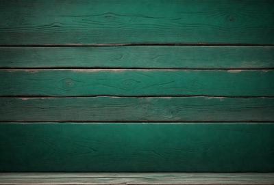 The primary subject of the image is a green wooden wall. The setting is a room with a green wall, and the visual style is a photo. The dominant colors are green, and the overall atmosphere is calm and serene.