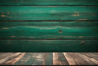 The primary subject of the image is a wooden wall with a green color. The setting is a room with a wooden floor. The visual style is a photo of a wooden wall. The dominant colors are green and brown, creating a warm and natural atmosphere.