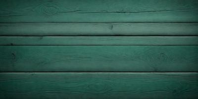 The primary subject of the image is a green wooden wall. The setting is a room with a green wall, and the visual style is a photo. The dominant colors are green, and the overall atmosphere is calm and serene.