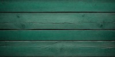 The primary subject of the image is a green wooden wall. The setting is a room with a green wall, and the visual style is a photo. The dominant colors are green, and the overall atmosphere is calm and natural.