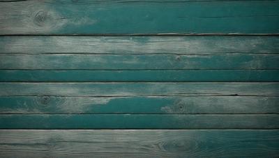 The primary subject of the image is a wooden wall with a blue color. The setting is a room with a blue wall, and the visual style is a photo. The dominant colors are blue and green, creating a calm and serene atmosphere.