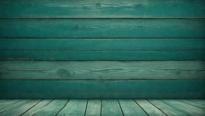 The primary subject of the image is a wooden wall with a blue color. The setting is a room with a wooden floor. The visual style is a photo, and the dominant colors are blue and green. The overall atmosphere is calm and serene.