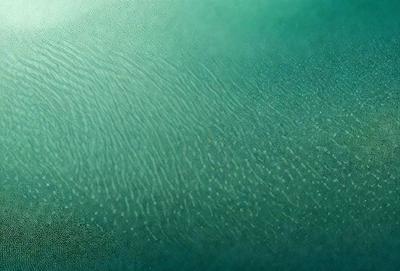 The primary subject of the image is a close-up of a green surface, possibly a piece of fabric or a wall. The setting appears to be a room with a green background. The visual style of the image is a close-up, which emphasizes the details of the green surface. The colors and mood of the image are predominantly green, creating a calm and soothing atmosphere.