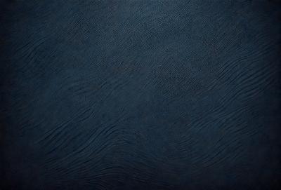 The primary subject of the image is a blue surface, which appears to be a wall or a piece of artwork. The setting is indoors, and the visual style is a close-up of the blue surface. The colors and mood of the image are predominantly blue, creating a calm and serene atmosphere.