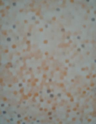 The primary subject of the image is a close-up of a wall with a pattern of dots. The setting is a room with a white surface, and the visual style appears to be a pattern or texture. The dominant colors in the image are orange and white, creating a warm and inviting atmosphere.