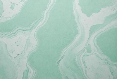 The image features a green and white marbled wallpaper with a pattern of swirls and waves. The wallpaper is displayed on a white background, creating a visually appealing contrast. The overall atmosphere of the image is serene and calming, with the green and white color scheme evoking a sense of tranquility.