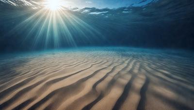 The primary subject of the image is a sandy beach with a sun shining on it. The setting is underwater, with the sunlight reflecting off the sand and creating a beautiful, serene atmosphere. The visual style is a photo, capturing the natural beauty of the underwater beach. The colors and mood are predominantly warm and inviting, with the sunlight creating a sense of tranquility and relaxation.