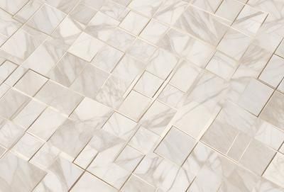The primary subject of the image is a white marble tile floor. The setting is a room with a white marble tile wall. The visual style is a close-up of the marble tile floor, showcasing the intricate patterns and textures. The colors and mood of the image are predominantly white, giving it a clean and elegant appearance.