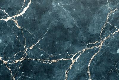 The primary subject of the image is a blue marble wall with a pattern of gold veins. The setting is a room with a blue marble floor. The visual style is a close-up of the marble wall, showcasing the intricate pattern of gold veins. The colors and mood of the image are predominantly blue and gold, creating a sense of luxury and elegance.