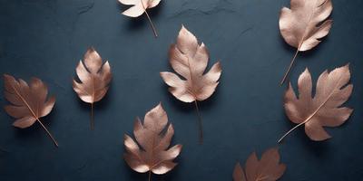 The primary subject of the image is a group of leaves, which are arranged in a visually appealing manner. The leaves are displayed on a blue background, creating a striking contrast. The visual style of the image is a combination of photo and digital art, as it appears to be a close-up of the leaves, yet the background is blue and the leaves are arranged in a way that suggests a digital artwork. The colors and mood of the image are predominantly blue and gold, giving it a warm and inviting atmosphere.