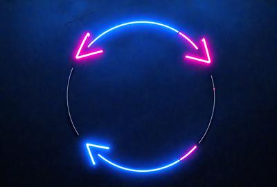 The primary subject of the image is a neon circle with arrows pointing inward. The circle is blue and pink, and it is placed against a dark blue background. The visual style of the image is digital art, as it appears to be a computer-generated or digitally edited image. The colors and mood of the image are vibrant and energetic, with the blue and pink neon circle standing out against the dark blue background.