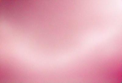 The primary subject of the image is a pink background. The setting is a pink surface, which creates a warm and inviting atmosphere. The visual style is a close-up of the pink background, emphasizing its color and texture. The colors and mood of the image are predominantly pink, giving it a soft and calming appearance.